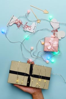 Christmas gift box for the New Year Christmas holiday on a blue pastel background. Vertical photo