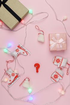 Question mark. Choosing a gift for New Year or Christmas. Top view, pink background. Vertical photo