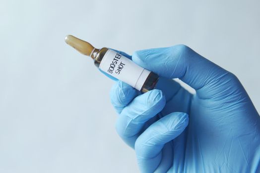 hand hold a booster shot dose coronavirus vaccine .