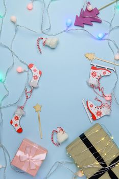 Xmas decorations gifts on blue background. New Year, winter concert. Flat lay, copy space. Vertical photo