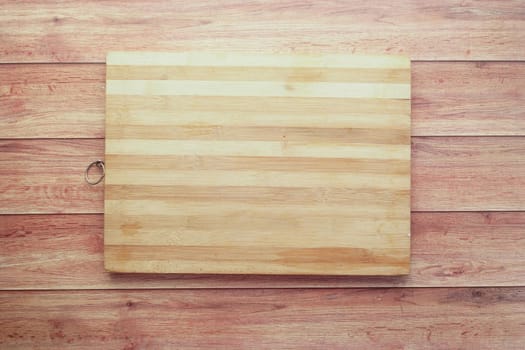 wooden chopping board on a table .