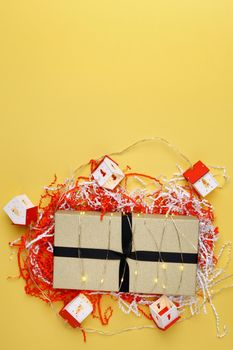 Christmas gift boxes. Happy New Year, Merry Christmas. Winter holiday theme. yellow background. Copy space. Vertical photo