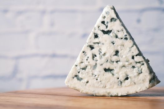 detail shot of blue cheese on table .