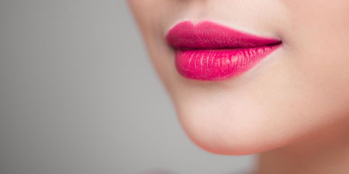 Beautiful young woman with bright lipstick, closeup