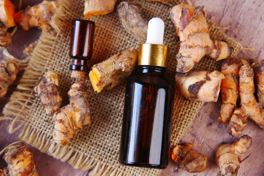 Oil of ginger in a glass bottle on table