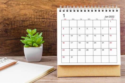 The January desk calendar 2022 on wooden background.