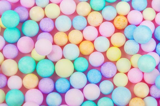 Foam beads of various colors brightly colored abstract background.