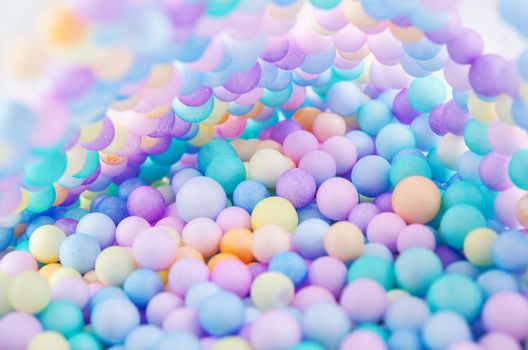 Foam beads of various colors brightly colored abstract background.
