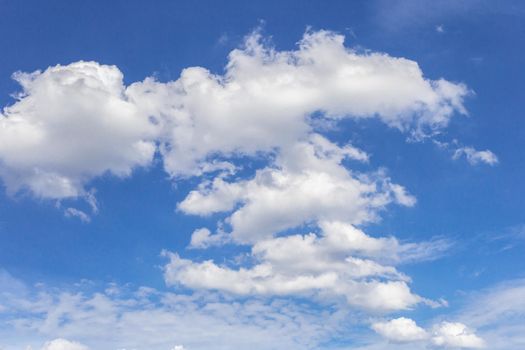 The blue sky background with tiny clouds.