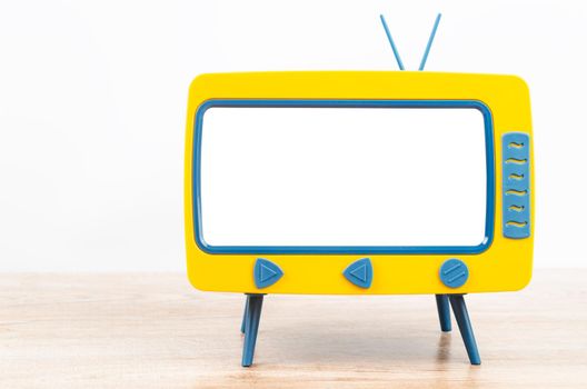 Vintage Miniature Toy Television on wooden table.
