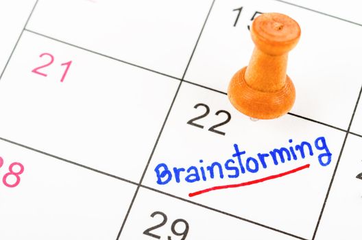 Handwritten Brainstorming for reminde apointment with wooden pin on a calendar.