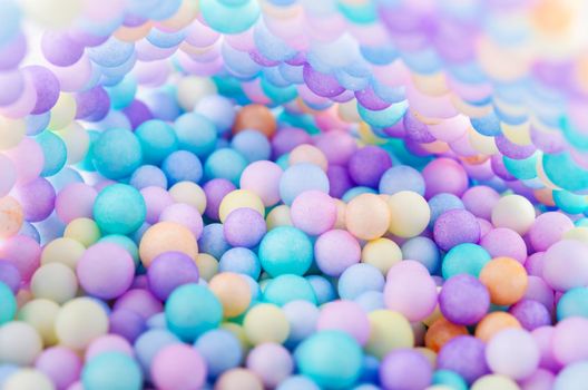 Foam beads of various colors brightly colored abstract background.