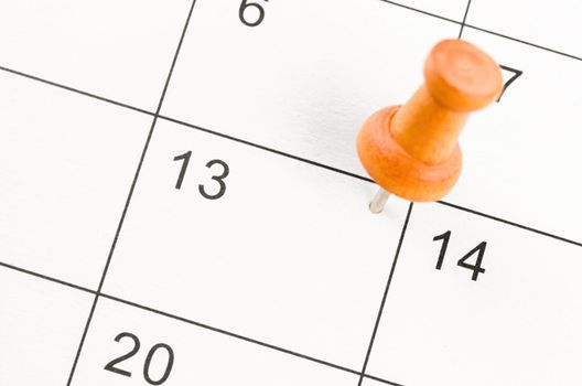 Embroidered wooden pin on a blank calendar on the 13rd for your text or message.