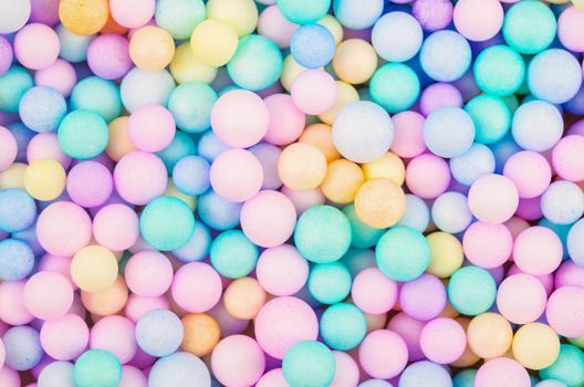 Foam beads of various colors brightly colored abstract background.