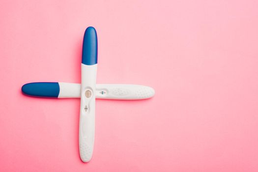 Pregnancy test on a pink background . Positive test. Pregnancy copy space. Motherhood