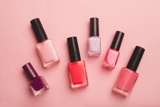 Pink nail polish on a pink copy space background. An article about nail polishes. Gel polish. An article about cosmetics. Decorative cosmetics . Pink background