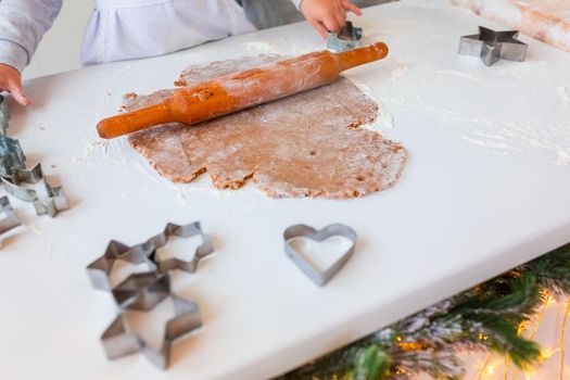 Christmas bakery. Friends making gingerbread, cutting cookies of gingerbread dough, view from above. Festive food, cooking process, family culinary, Christmas and New Year traditions concept