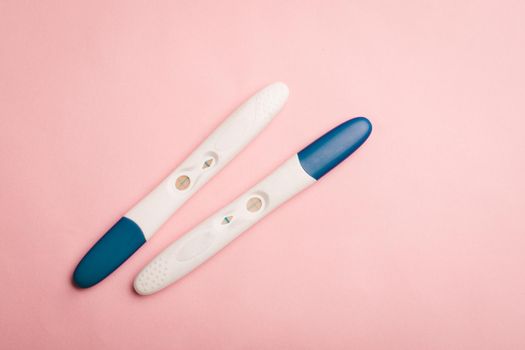 Pregnancy test on a pink background . Positive test. Pregnancy copy space. Motherhood