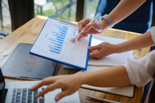 Analytics intelligence concept. Group of business people discuss current financial and economic on laptop for investment at the meeting