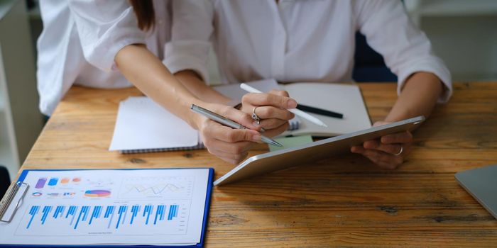 Business team working together and training to analyze technical price graph and indicator. Chart and stock trading computer screen