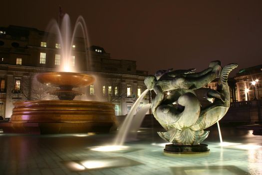 The fountains in Trafalgar Square London at night