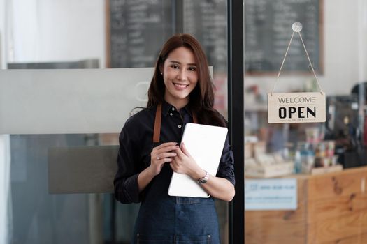 Portrait of Startup successful small business owner in coffee shop.handsome woman barista cafe owner. SME entrepreneur seller business concept.