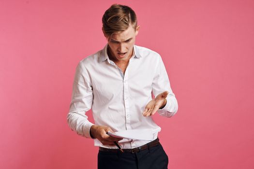 businessmen in a white shirt talking on the phone pink background. High quality photo