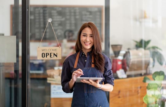Portrait of Startup successful small business owner in coffee shop.handsome woman barista cafe owner. SME entrepreneur seller business concept.