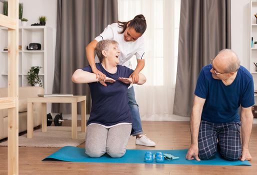 Doctor providing home health services Home assistance, physiotherapy, healthy lifestyle for senior old person, training and recovery with professional physiotherapist
