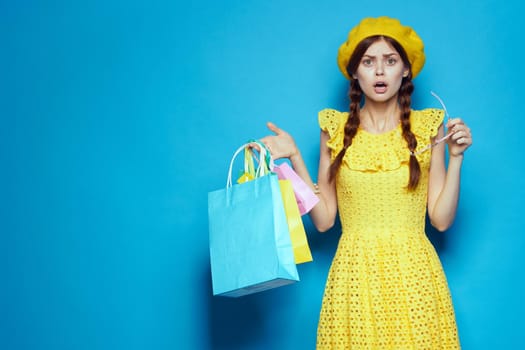 pretty woman with multicolored bags posing studio model. High quality photo