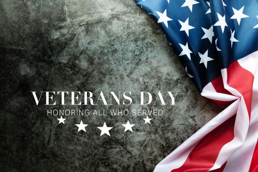 Veterans day. Honoring all who served. American flag on cement background
