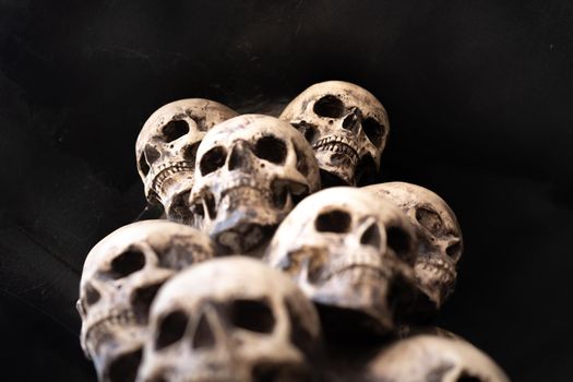 Skull Halloween Background Many People Skulls Stand on top of each other. Mystic creepy concept. Abstract nightmare occult memorial.