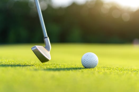 Golf ball with golf club on green field grass sunny summer day Nobody