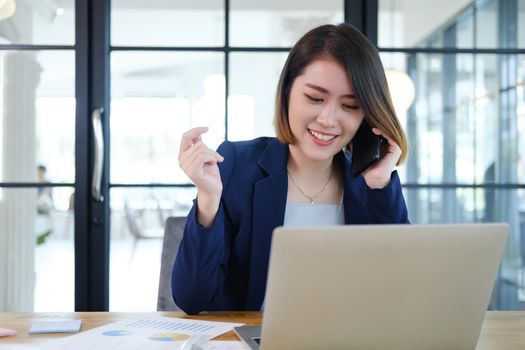 Portrait of beautiful and smart young entrepreneur businesswoman working in modern work station.