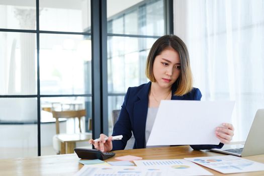 Portrait of beautiful and smart young entrepreneur businesswoman working in modern work station.