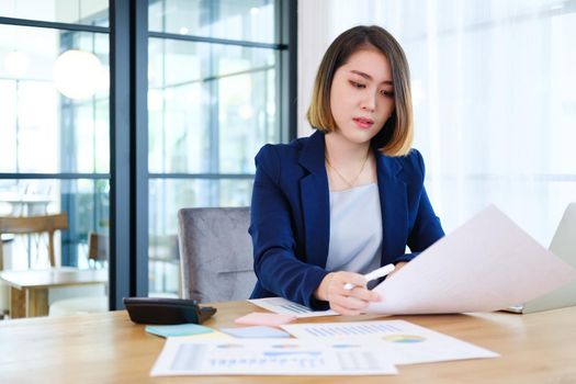 Portrait of beautiful and smart young entrepreneur businesswoman working in modern work station.