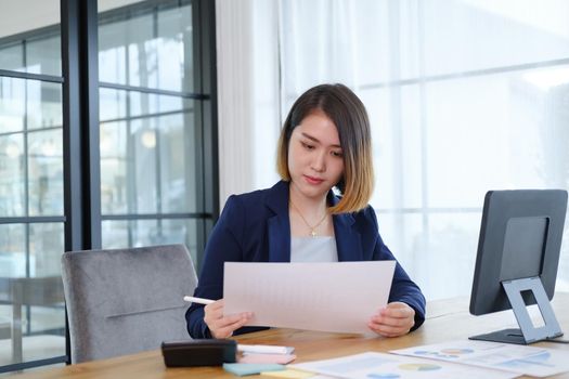 Portrait of beautiful and smart young entrepreneur businesswoman working in modern work station.