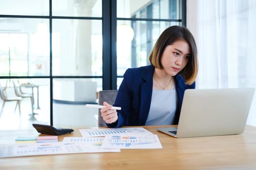 Portrait of beautiful and smart young entrepreneur businesswoman working in modern work station.