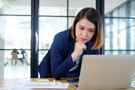 Portrait of beautiful and smart young entrepreneur businesswoman working in modern work station.