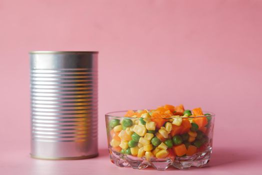 Open can of fruit cocktail on table