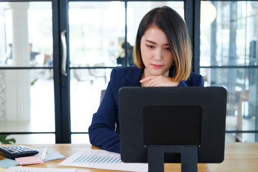 Portrait of beautiful and smart young entrepreneur businesswoman working in modern work station.