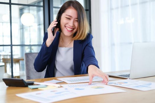 Portrait of beautiful and smart young entrepreneur businesswoman working in modern work station.