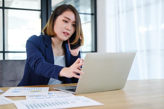 Portrait of beautiful and smart young entrepreneur businesswoman working in modern work station.