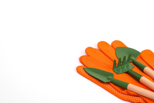 Mini tools for flowers - shovel, rake. Protective knitted point gloves for gardening. On a white background. copy space. layout.