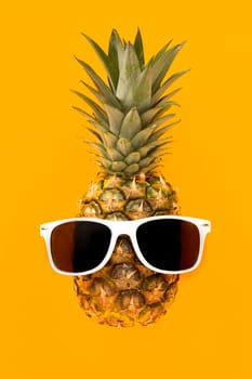 top view exotic pineapple with sunglasses. High resolution photo