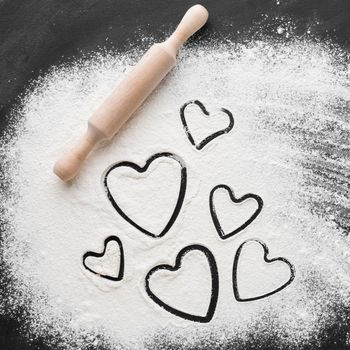 flat lay heart shapes flour with rolling pin. High resolution photo