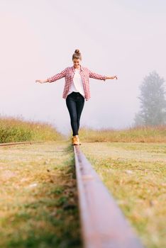 low angle young girl balancing railway. High resolution photo