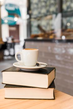 cup coffee books wooden table. High resolution photo