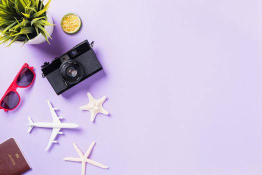 Top view flat lay mockup of retro camera films, airplane, sunglasses, starfish traveler accessories isolated on a purple background with copy space, Business trip, and vacation summer travel concept