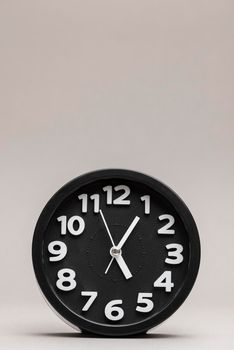 close up black alarm clock plain background. High resolution photo